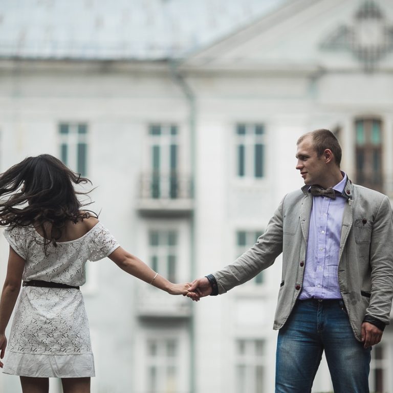 Young and beautiful European couple having a great time on the background of the city